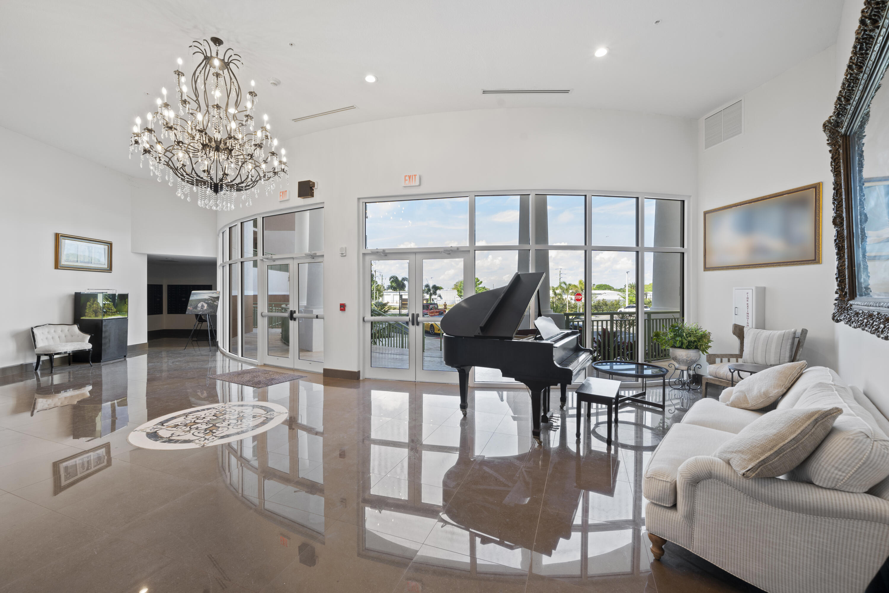 735 Pilot Lane, Unit 1004 Merritt Island, FL 32952 - Photo 5 of 46 a living room with furniture a chandelier and a floor to ceiling window