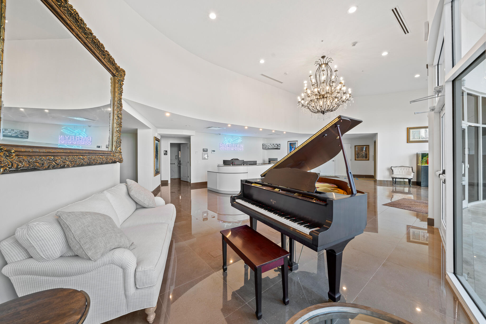 735 Pilot Lane, Unit 1004 Merritt Island, FL 32952 - Photo 6 of 46 a living room with furniture a piano and a chandelier