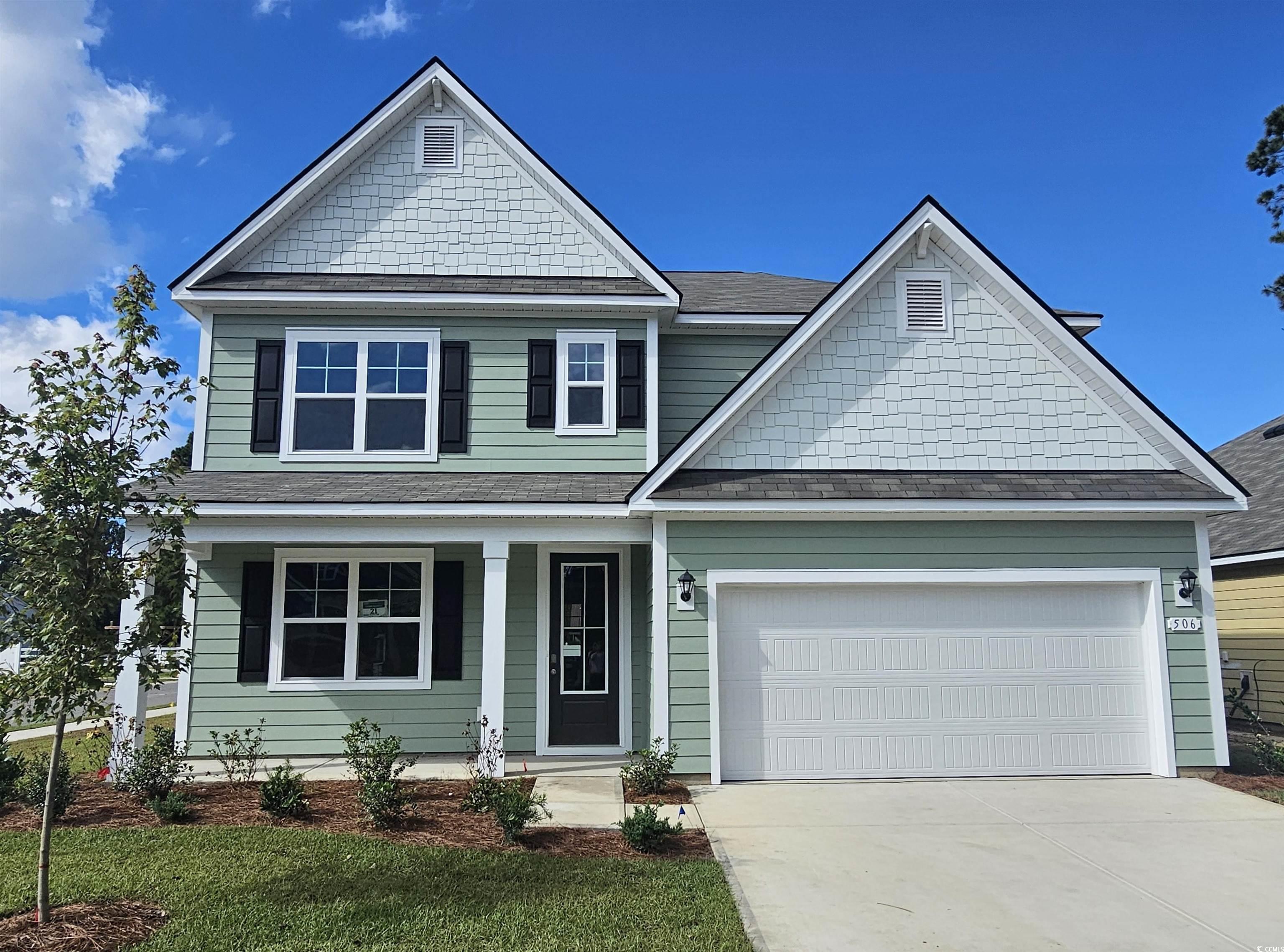 506 Haven View Way Murrells Inlet, SC 29576 - Photo 1 of 40 View of front facade with driveway, covered porch, a front lawn, roof with shingles, and a garage