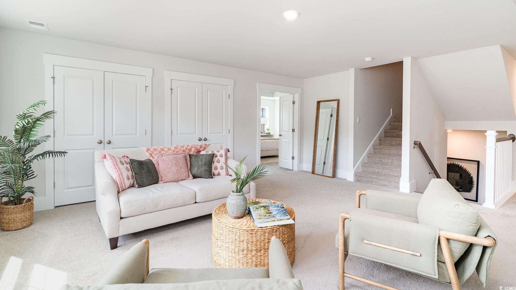 506 Haven View Way Murrells Inlet, SC 29576 - Photo 25 of 40 Living room featuring light carpet, baseboards, and stairs