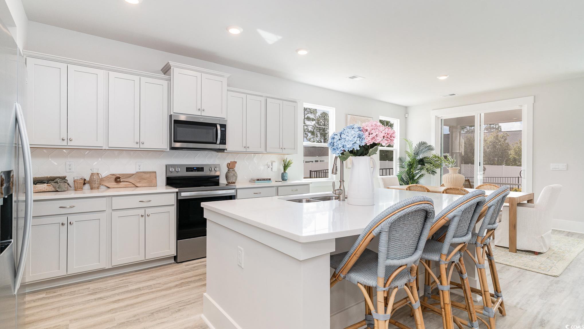 506 Haven View Way Murrells Inlet, SC 29576 - Photo 10 of 40 Kitchen featuring stainless steel appliances, a sink, healthy amount of natural light, a kitchen island with sink, and recessed lighting