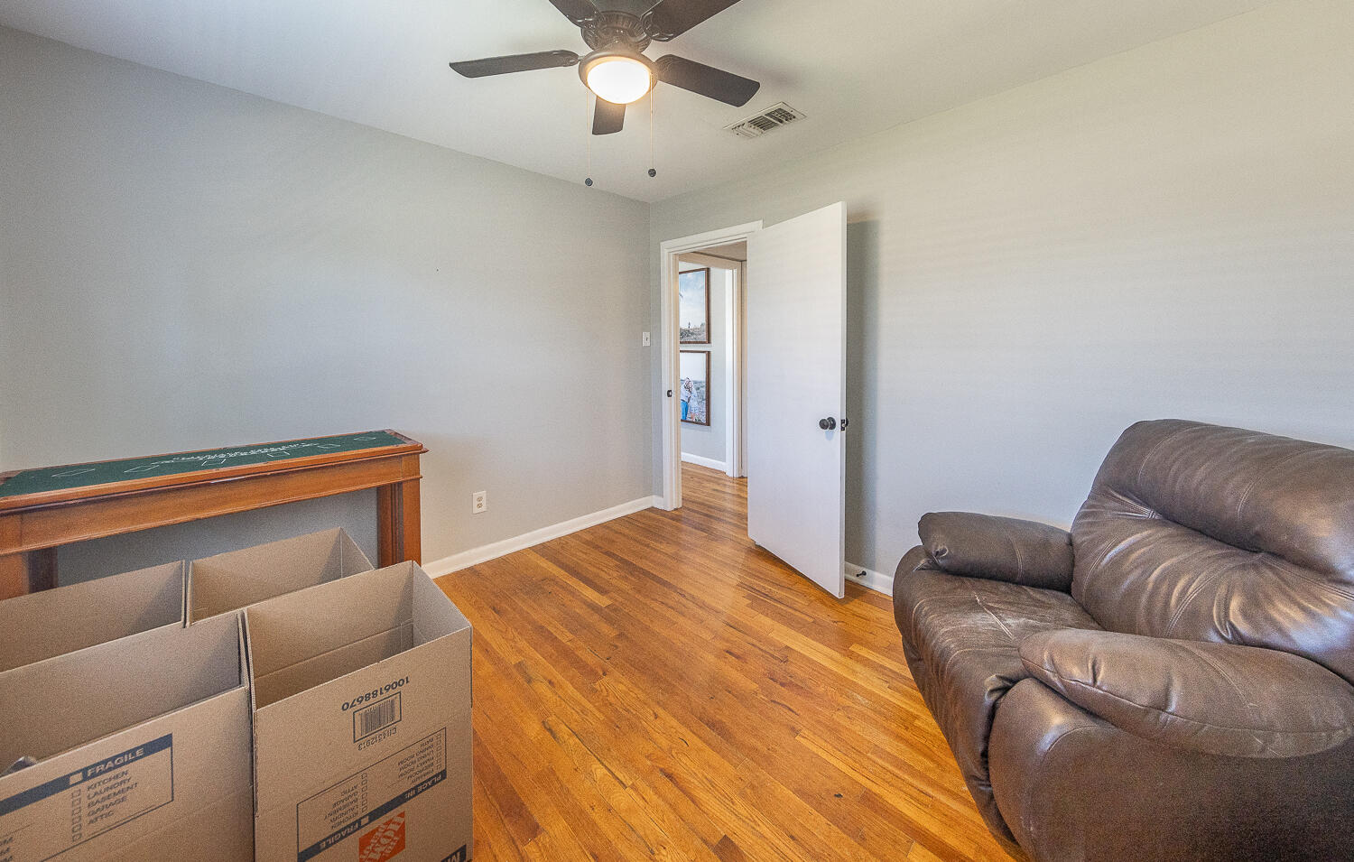 4206 42nd Street Lubbock, TX 79413 - Photo 12 of 25 a bedroom with a bed couch and ceiling fan
