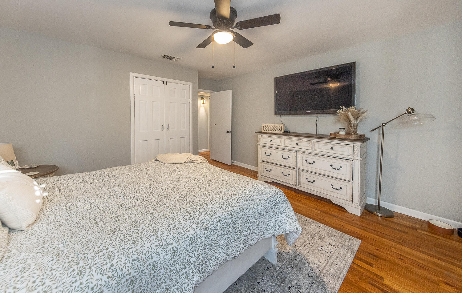 4206 42nd Street Lubbock, TX 79413 - Photo 14 of 25 a spacious bedroom with a bed and flat screen tv