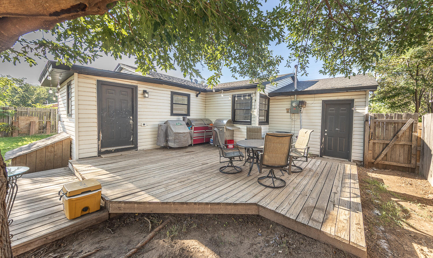 4206 42nd Street Lubbock, TX 79413 - Photo 20 of 25 a view of a patio with a table chairs and wooden floor