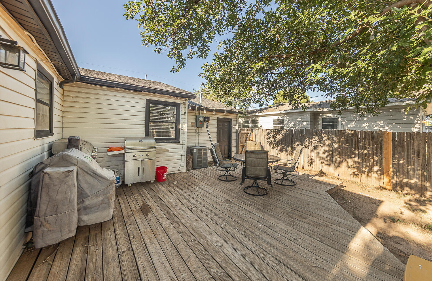 4206 42nd Street Lubbock, TX 79413 - Photo 23 of 25 a view of a deck with table and chairs with wooden floor and fence