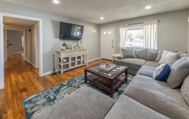 a living room with furniture and a flat screen tv