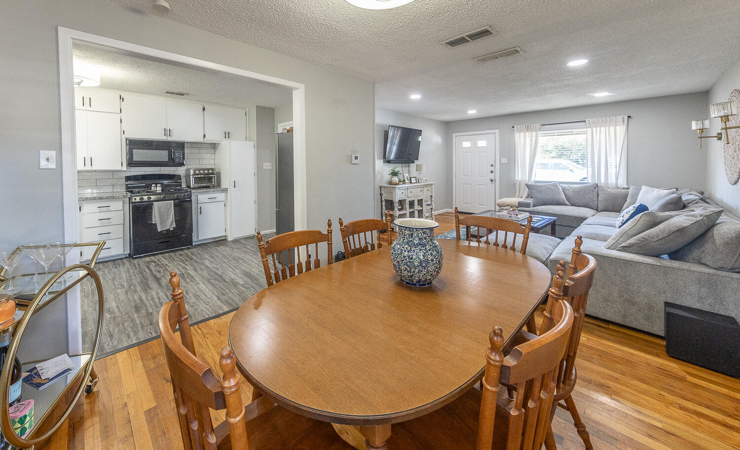 4206 42nd Street Lubbock, TX 79413 - Photo 6 of 25 a living room with stainless steel appliances furniture dining table and wooden floor