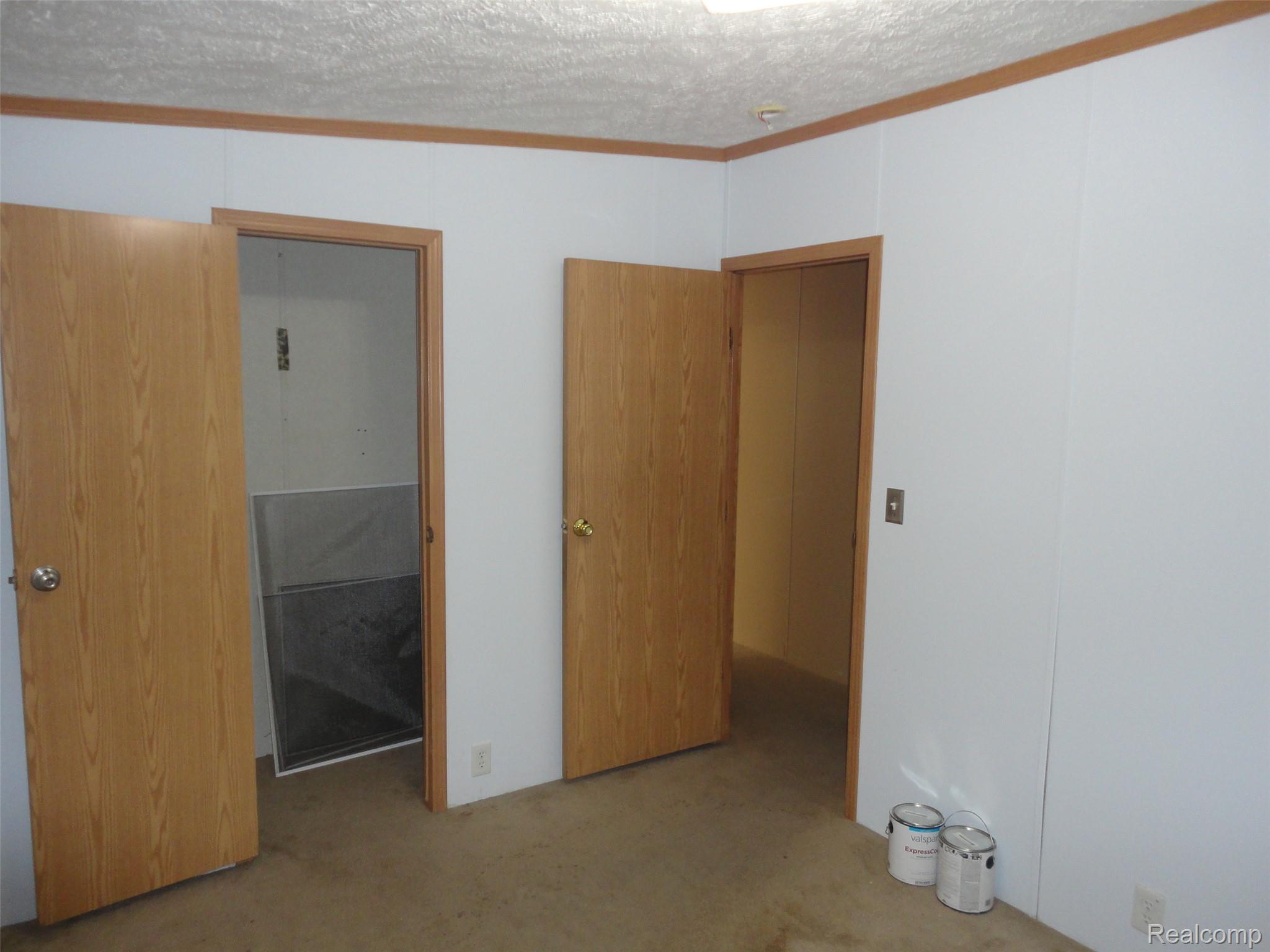 3954 Ryans Ridge Monroe, MI 48161 - Photo 20 of 28 Bedroom 3 featuring light-colored walls and wood-finish trim, with two wood-finish doors