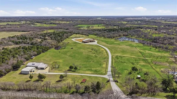 an aerial view of a residential houses with outdoor space