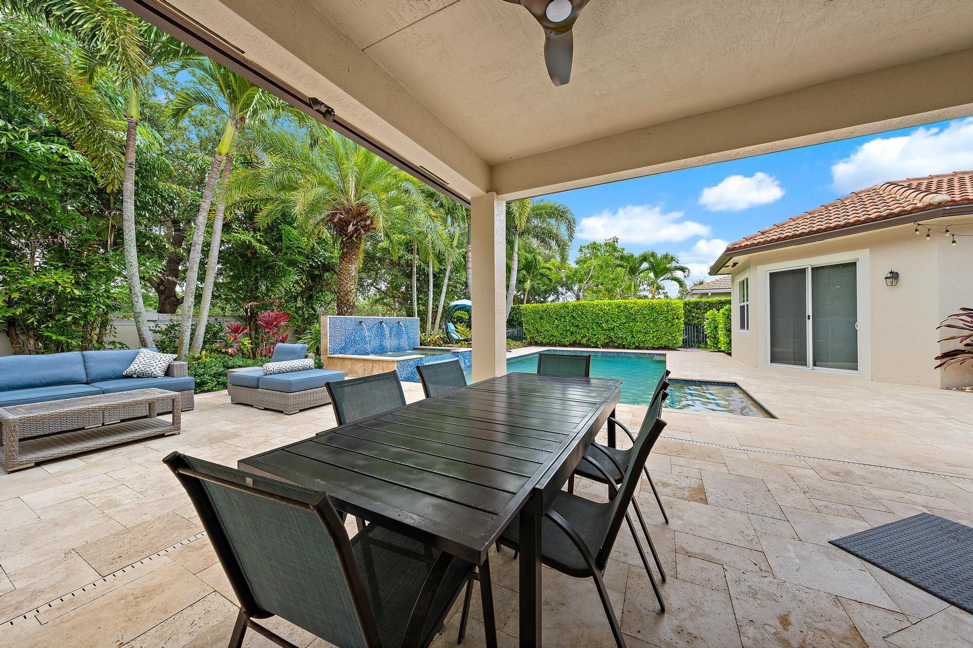 283 Rudder Cay Way Jupiter, FL 33458 - Photo 9 of 41 a outdoor space with patio the couches and a dining table with garden view