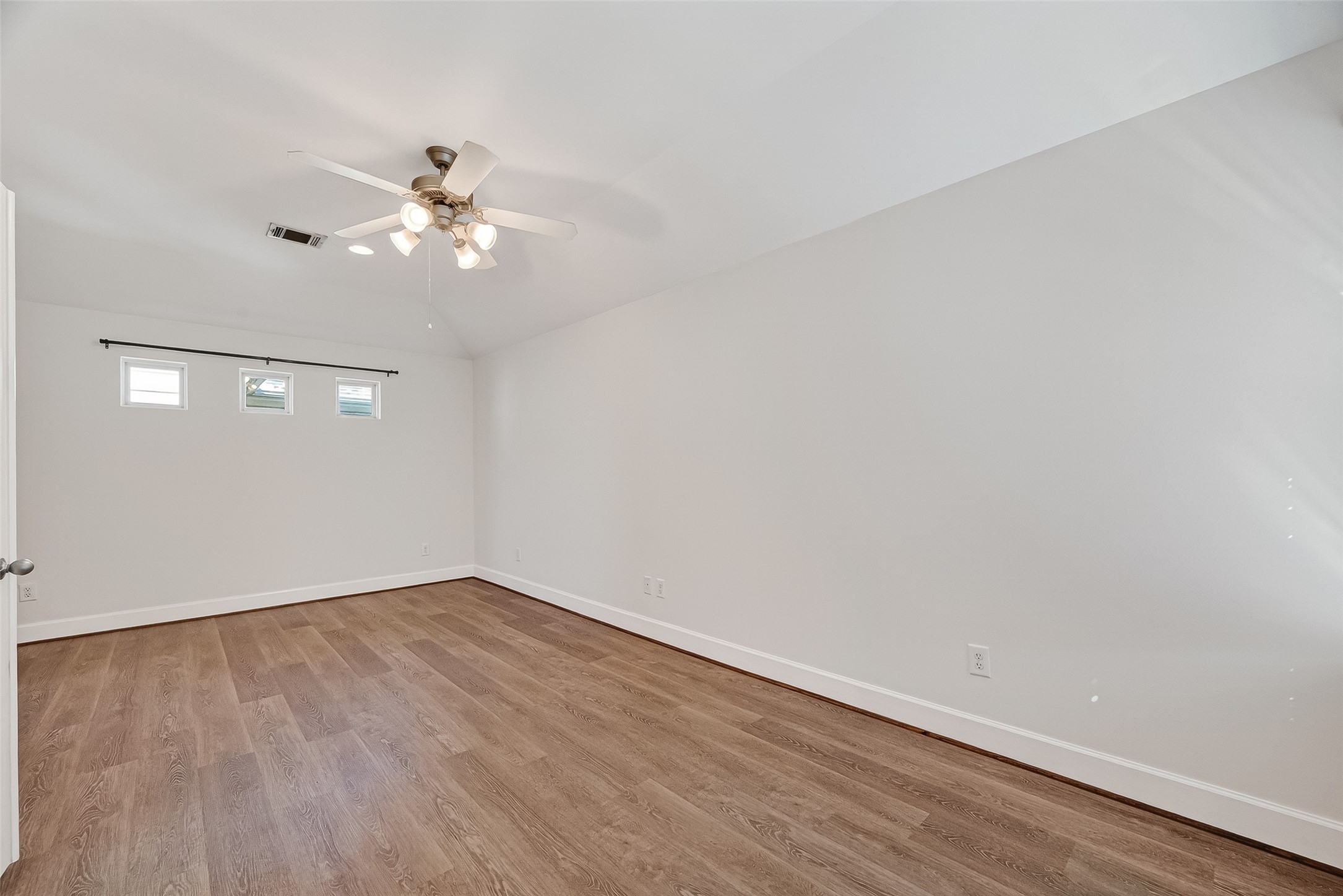 5951 S Loop East, Unit 47 Houston, TX 77033 - Photo 15 of 37 The Primary bedroom is a spacious, well-lit room featuring hardwood floors, neutral walls, a ceiling fan.