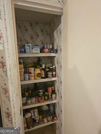 a room with water heater and shelf