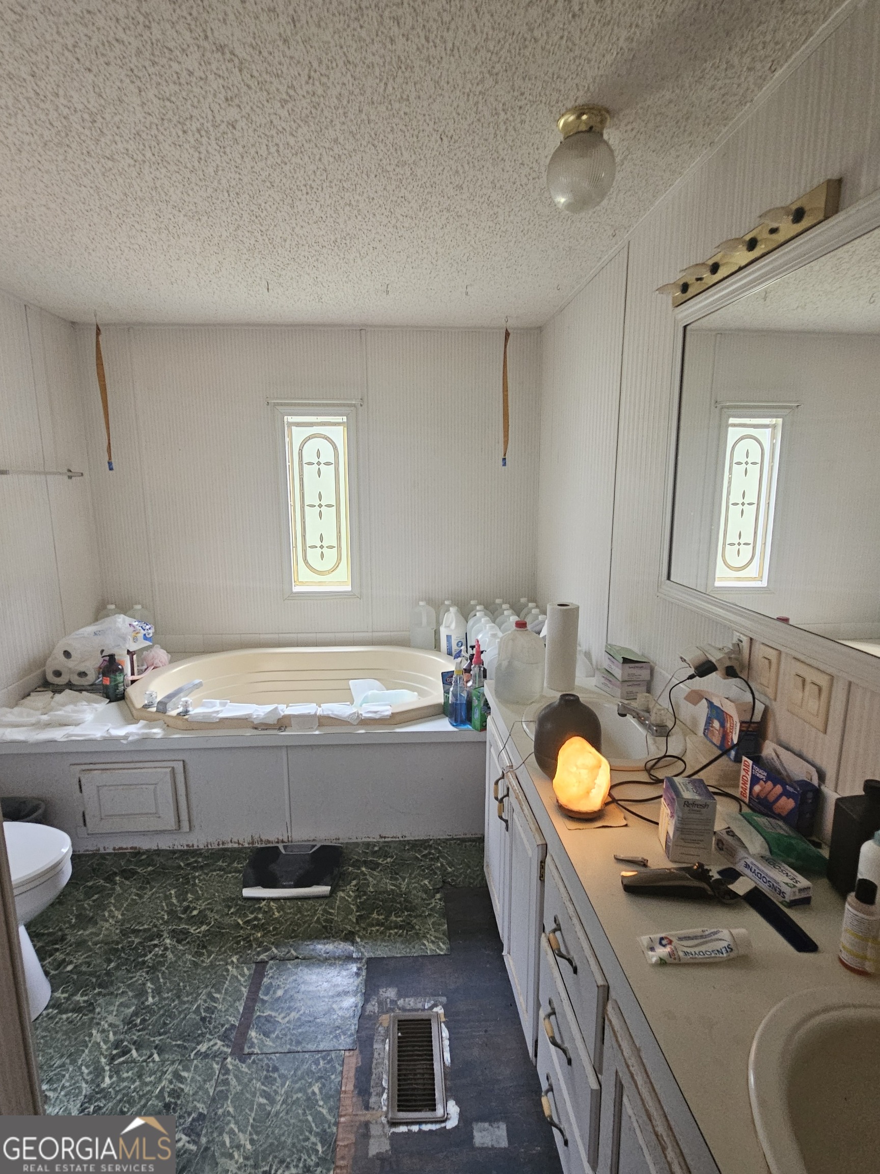 267 Williams Road Tallapoosa, GA 30176 - Photo 8 of 14 a bathroom with a granite countertop tub and a sink
