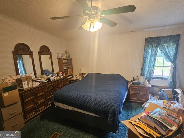 a bedroom with bed or couch and a chandelier