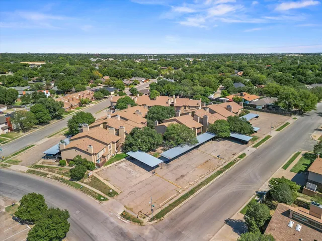 an aerial view of a house with a yard