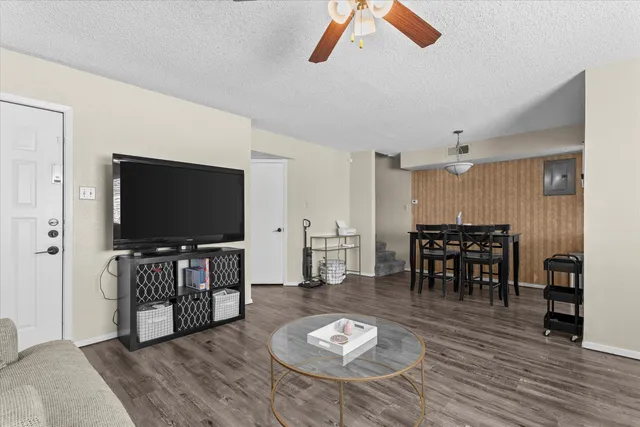 a view of a a dining room with furniture window and wooden floor
