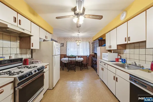 a kitchen with a sink stainless steel appliances a window and a counter top space