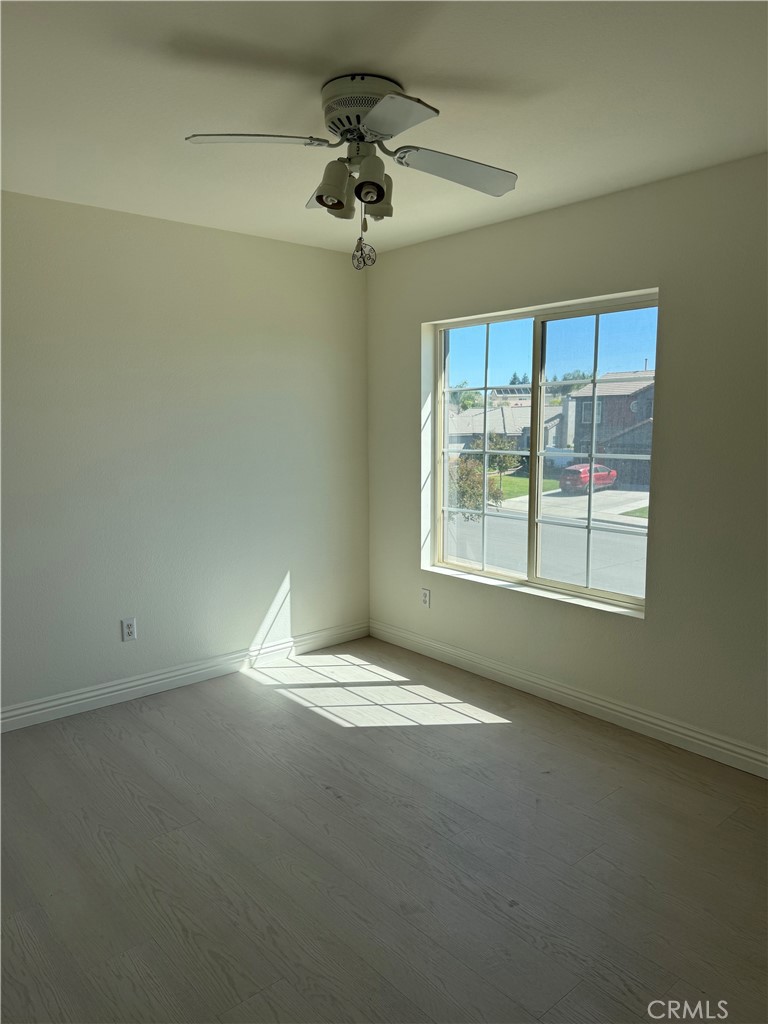 1657 Stone Creek Road Beaumont, CA 92223 - Photo 19 of 32 a view of room with a ceiling fan and window