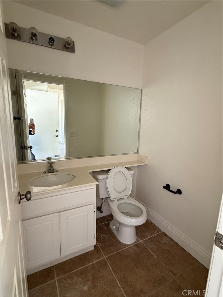1657 Stone Creek Road Beaumont, CA 92223 - Photo 24 of 32 a bathroom with a toilet sink and mirror