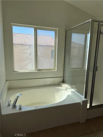 a bathroom with a bathtub and a shower