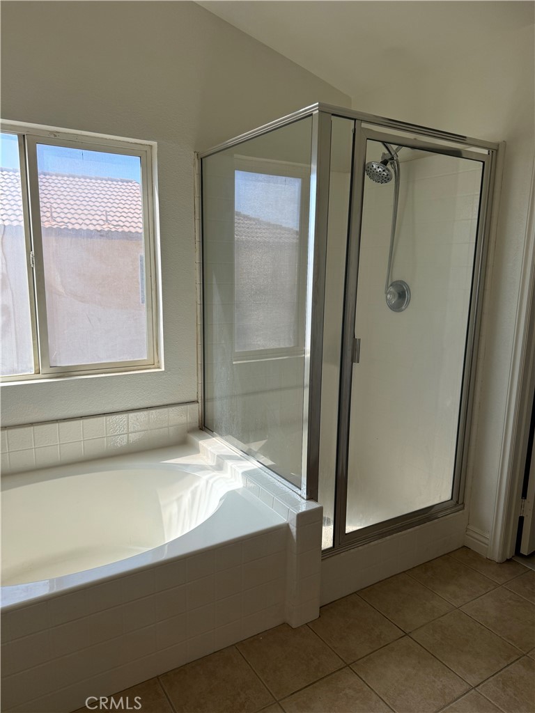 1657 Stone Creek Road Beaumont, CA 92223 - Photo 27 of 32 a bathroom with a bathtub and a shower