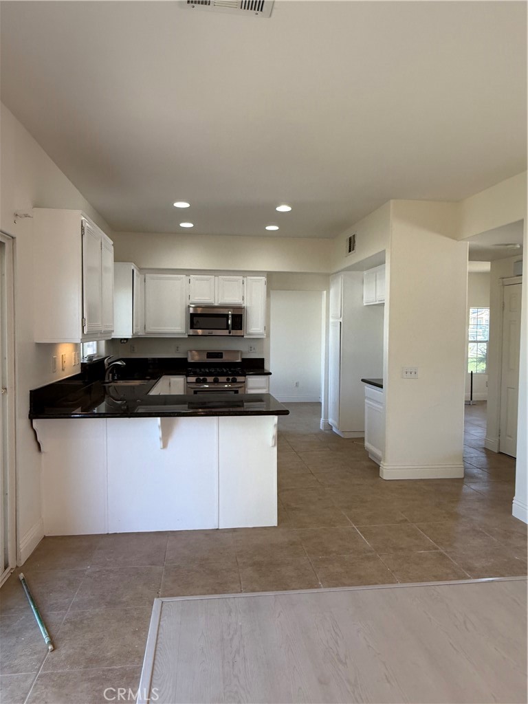 1657 Stone Creek Road Beaumont, CA 92223 - Photo 6 of 32 a view of kitchen with refrigerator stove and a sink