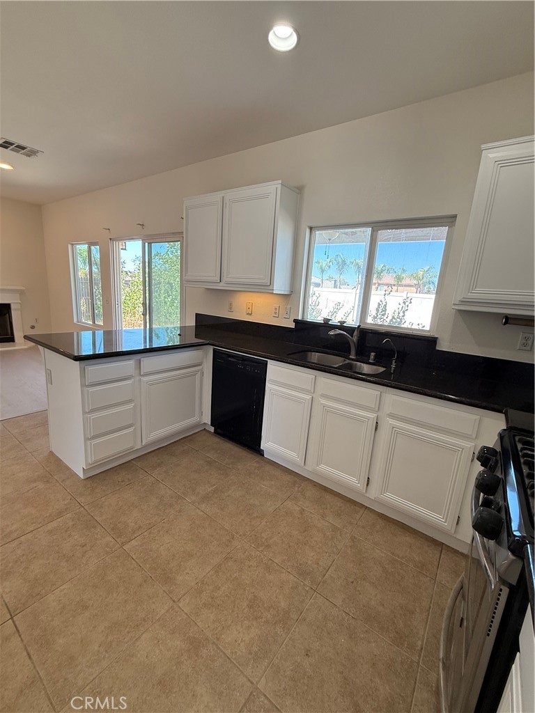 1657 Stone Creek Road Beaumont, CA 92223 - Photo 8 of 32 a kitchen with granite countertop a stove a sink and a granite counter tops