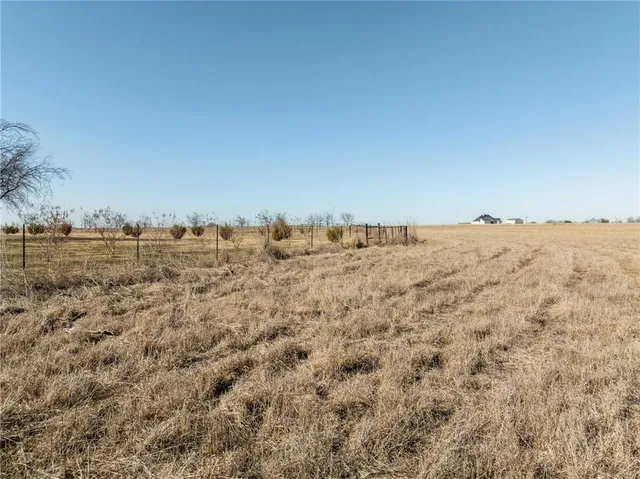 a view of a large building with mountains in the background