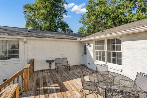 a view of roof deck with chair and wooden floor