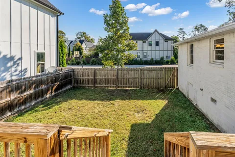 a view of house with yard and sitting area