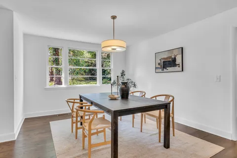 a view of a dining room with a table and chairs