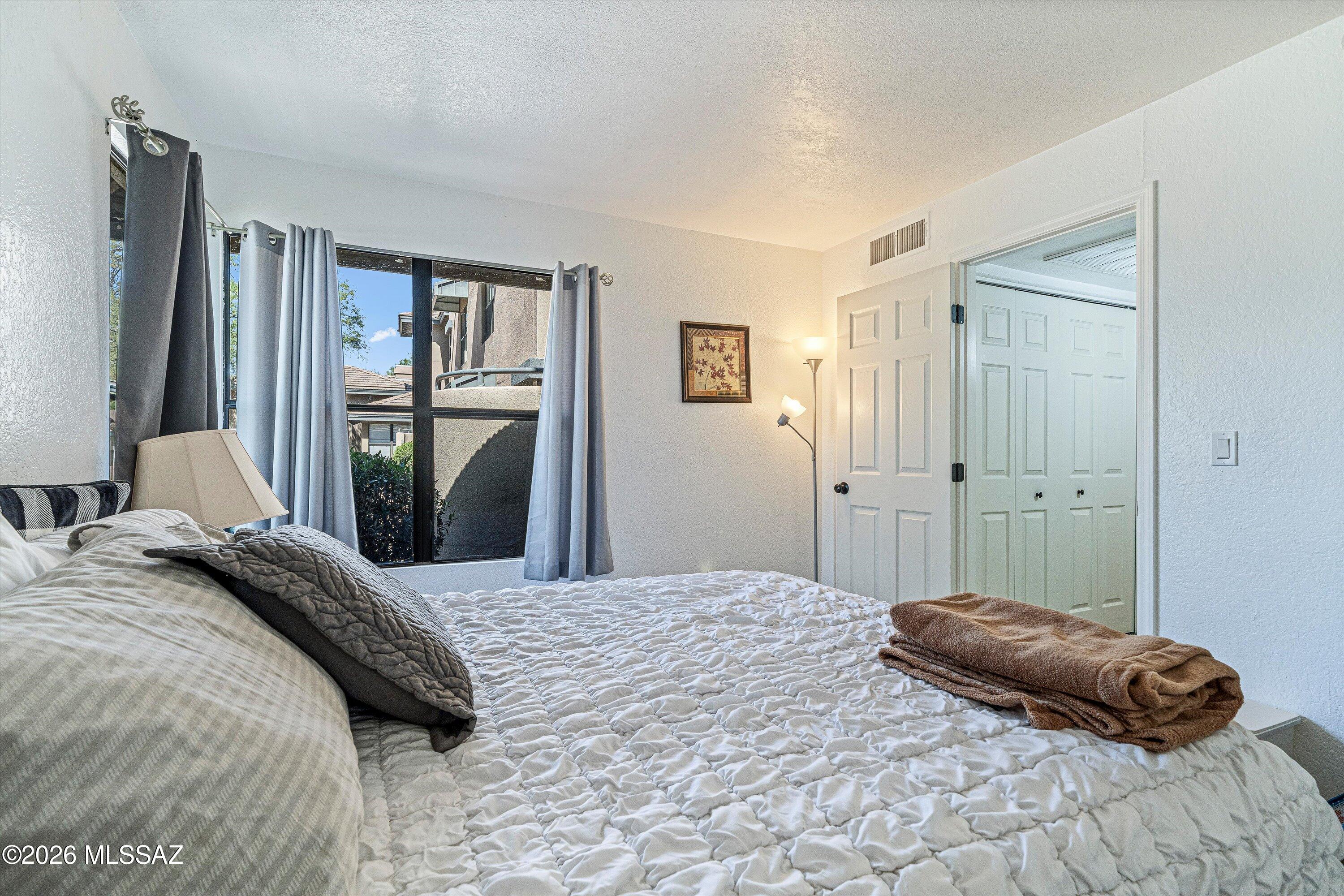 5800 North Kolb Road, Unit 1102 Tucson, AZ 85750 - Photo 16 of 36 a bedroom with a bed and a walk in closet