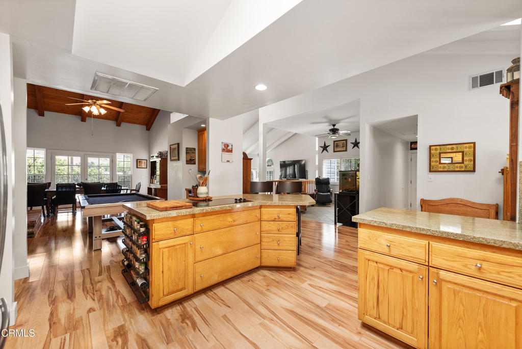 4850 North Moorpark Road Thousand Oaks, CA 91360 - Photo 14 of 54 a large kitchen with stainless steel appliances granite countertop a lot of counter space and wooden floors