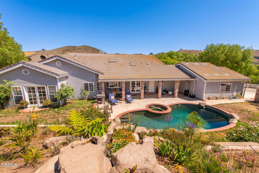 4850 North Moorpark Road Thousand Oaks, CA 91360 - Photo 37 of 54 a front view of a house with swimming pool and furniture