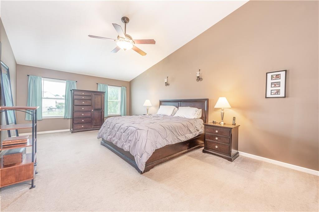 409 Commodore Drive McDonald, PA 15057 - Photo 26 of 49 a spacious bedroom with a bed and a chandelier