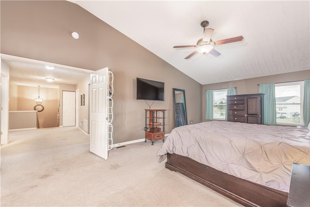 409 Commodore Drive McDonald, PA 15057 - Photo 27 of 49 a spacious bedroom with a large bed a chandelier and closet