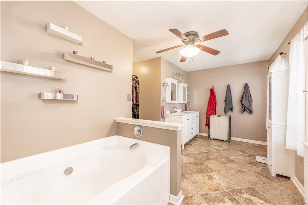 409 Commodore Drive McDonald, PA 15057 - Photo 29 of 49 a bathroom with a tub sink and a chandelier