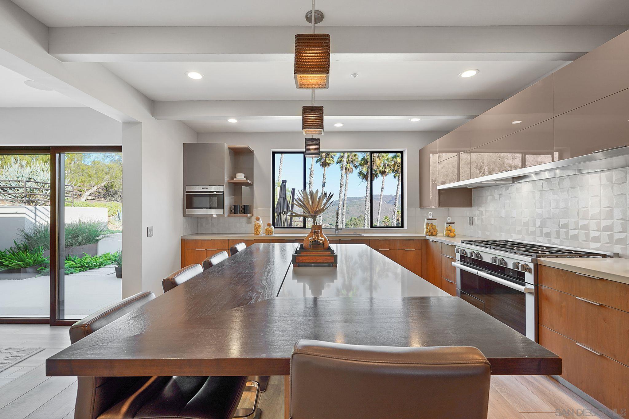 19969 Elfin Forest Lane Escondido, CA 92029 - Photo 17 of 53 an open kitchen with wooden floor and stainless steel appliances