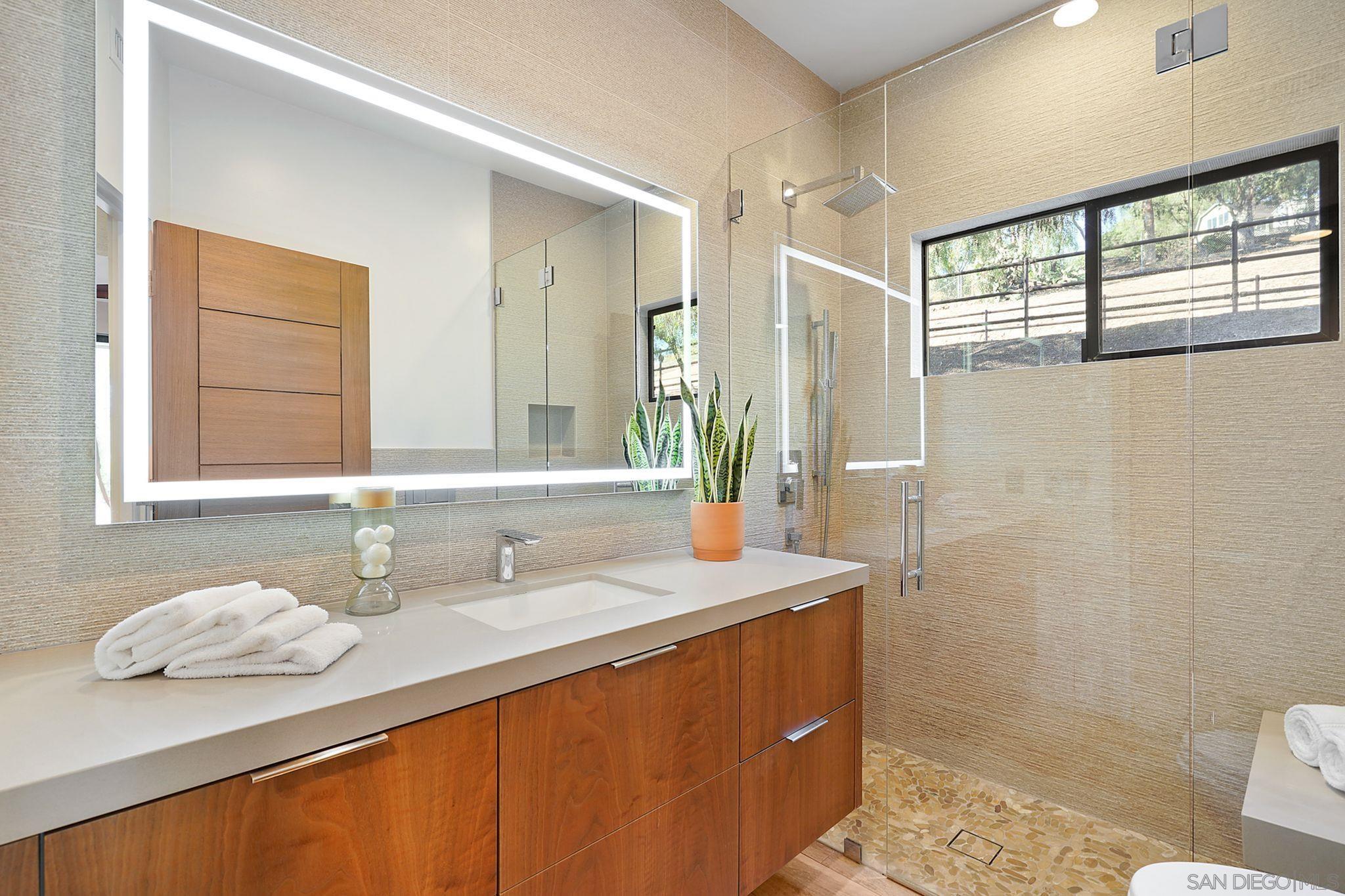 19969 Elfin Forest Lane Escondido, CA 92029 - Photo 24 of 53 a bathroom with a granite countertop sink and a mirror