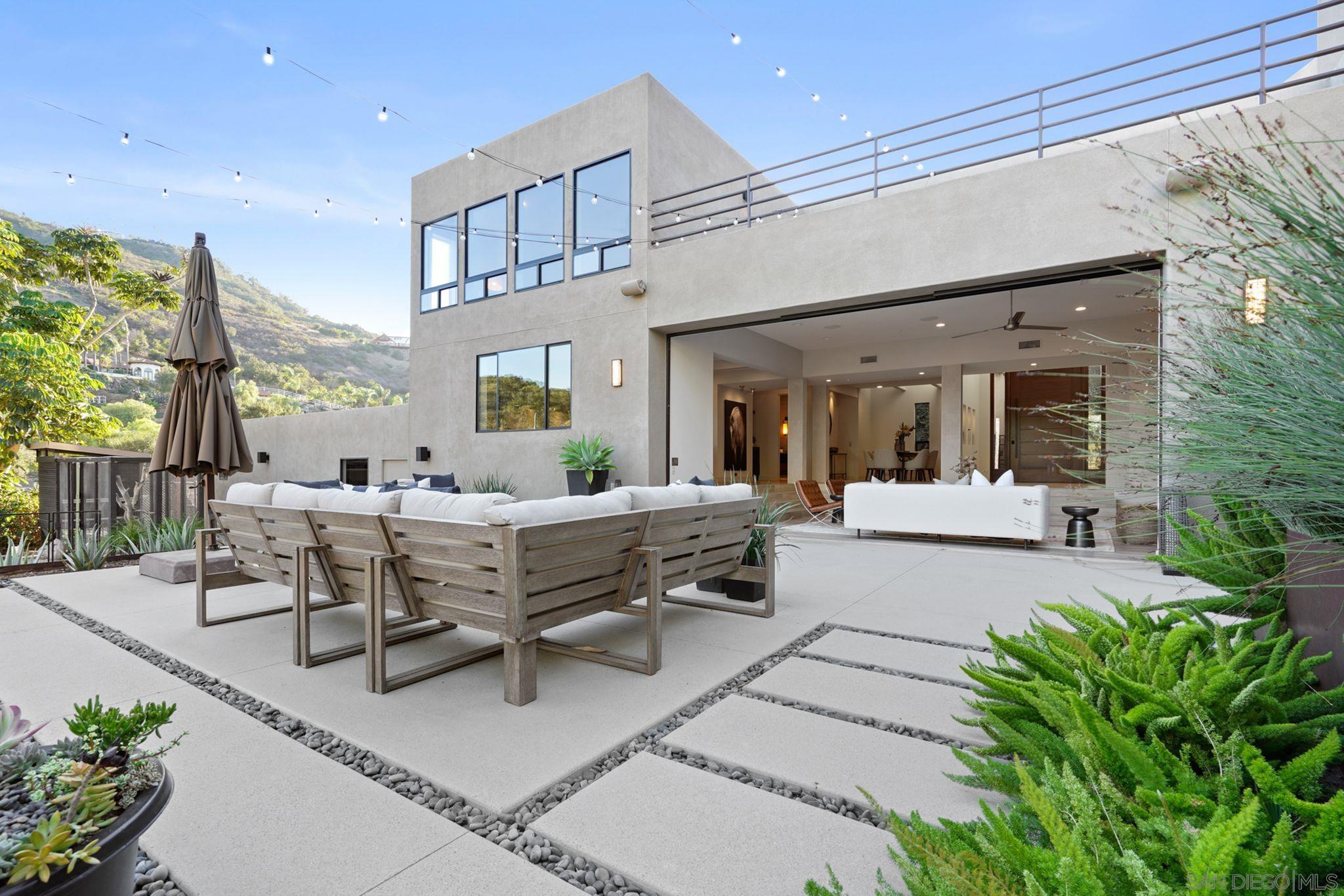 19969 Elfin Forest Lane Escondido, CA 92029 - Photo 34 of 53 a view of a patio with dining table and chairs with potted plants