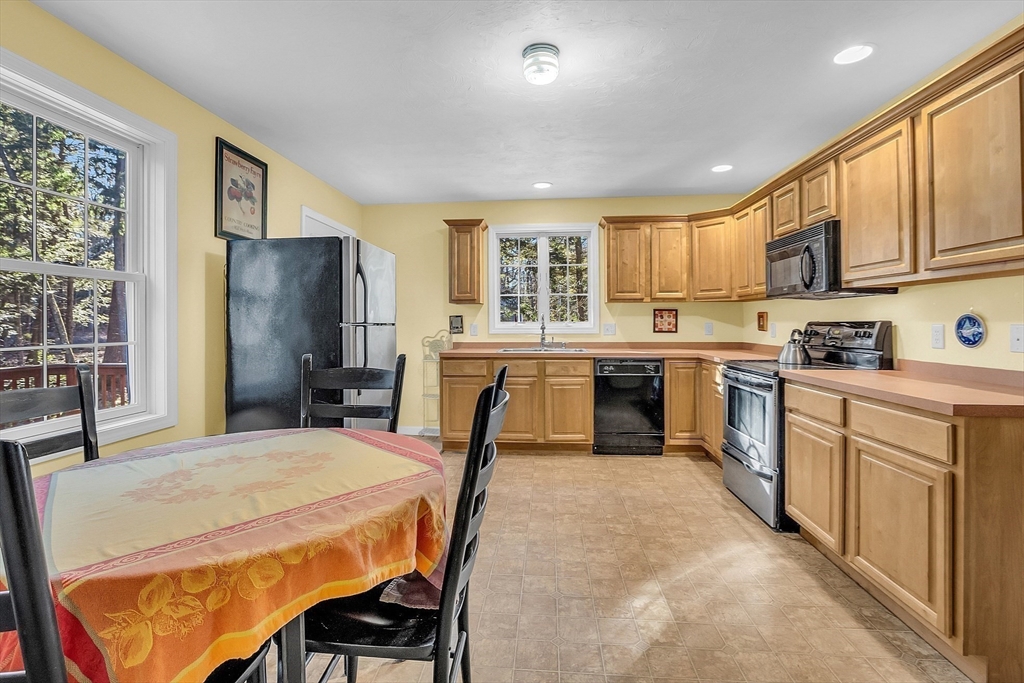 170 E Road, Unit 1 Orange, MA 01364 - Photo 12 of 22 a kitchen with a table chairs sink refrigerator and cabinets