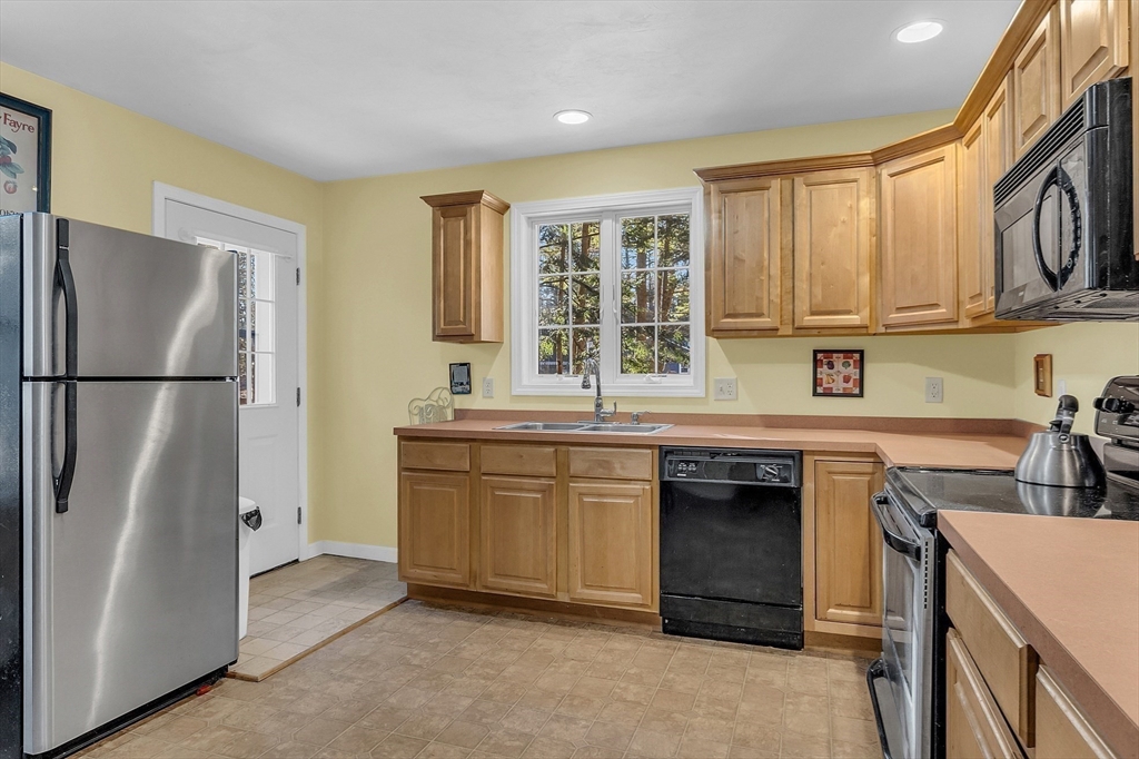 170 E Road, Unit 1 Orange, MA 01364 - Photo 13 of 22 a kitchen with stainless steel appliances granite countertop a refrigerator a sink dishwasher a stove and a refrigerator