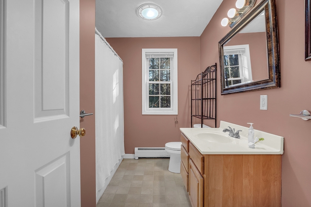 170 E Road, Unit 1 Orange, MA 01364 - Photo 15 of 22 a bathroom with a sink a vanity and a mirror