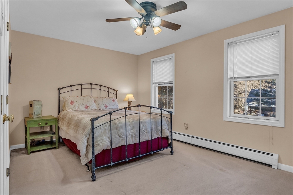 170 E Road, Unit 1 Orange, MA 01364 - Photo 16 of 22 a bedroom with a bed and a chandelier