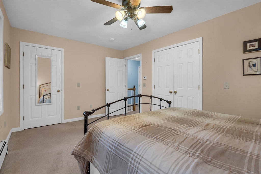 170 E Road, Unit 1 Orange, MA 01364 - Photo 18 of 22 a bedroom with a bed and a chandelier