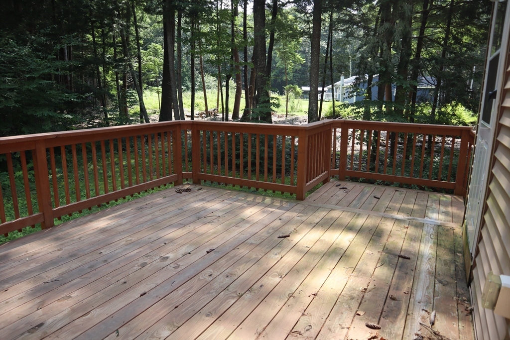 170 E Road, Unit 1 Orange, MA 01364 - Photo 6 of 22 a view of deck with wooden floor and fence