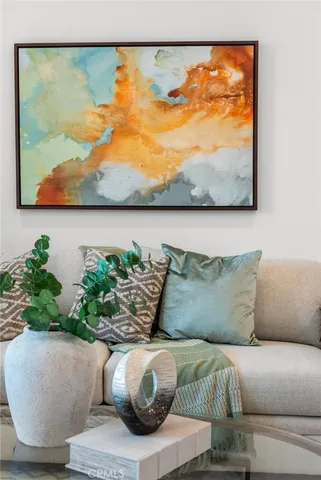 a living room with furniture and painting on the wall