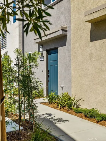 an aerial view of residential houses with outdoor space and ocean view