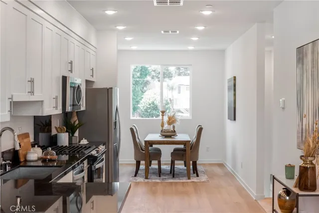 a view of a dining room with furniture and a window