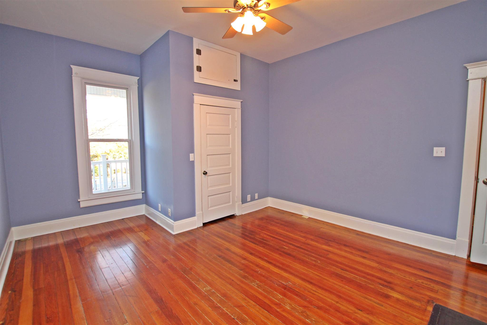 317 North Main Street Springfield, TN 37172 - Photo 17 of 30 an empty room with wooden floor chandelier fan and windows